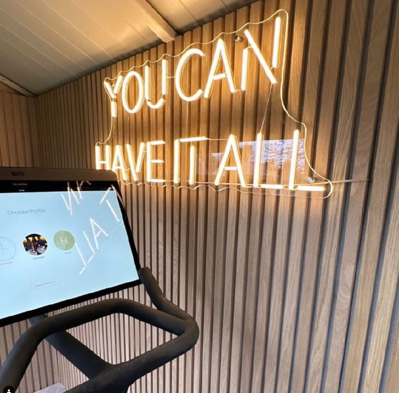 Warm white You Can Have It All LED neon quote sign on a wooden slat wall